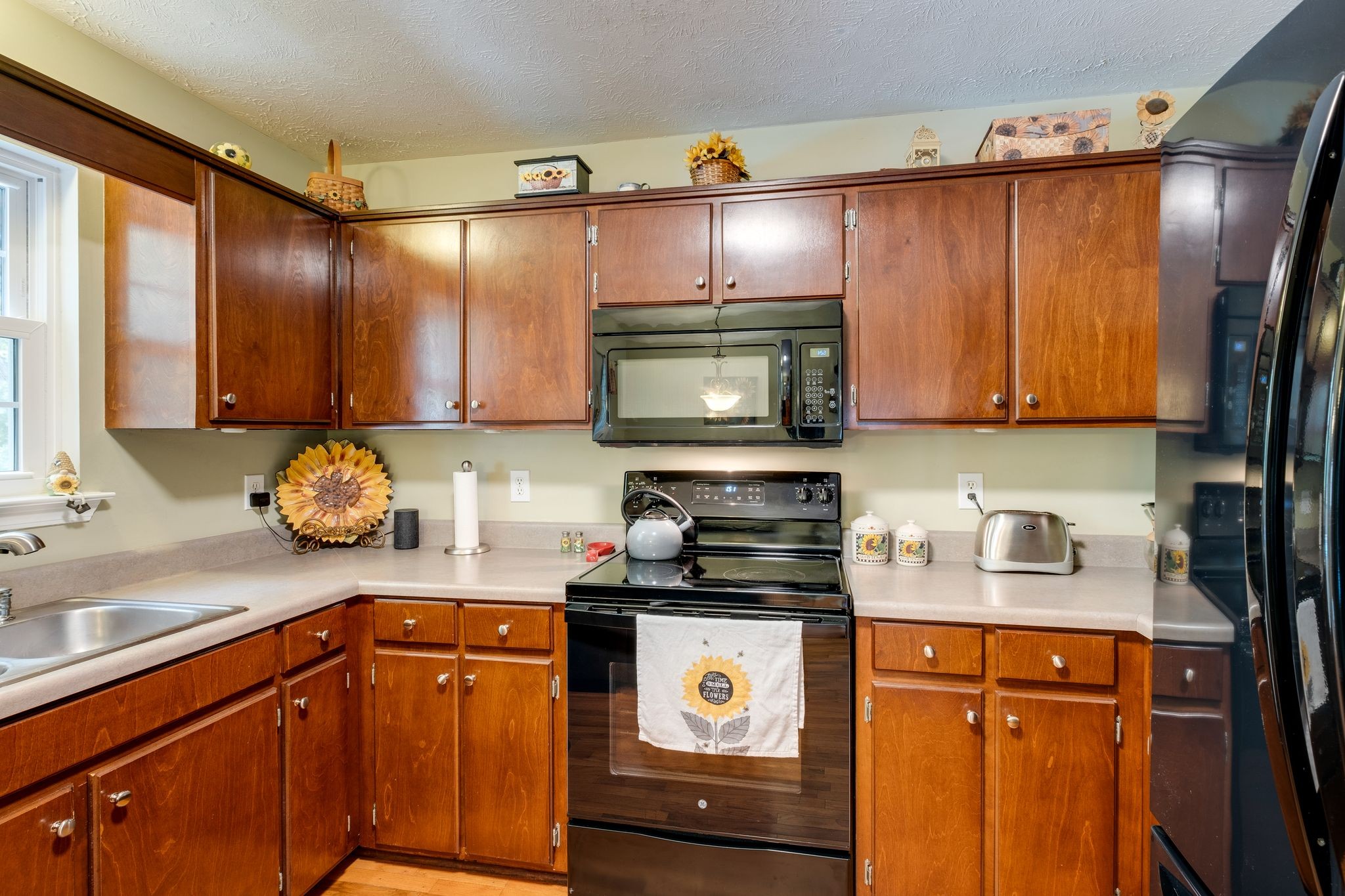 1040 Windtree Trace Mount Juliet, TN 37122 - Photo 13 of 30 a kitchen with stainless steel appliances wooden cabinets a stove top oven a sink and dishwasher