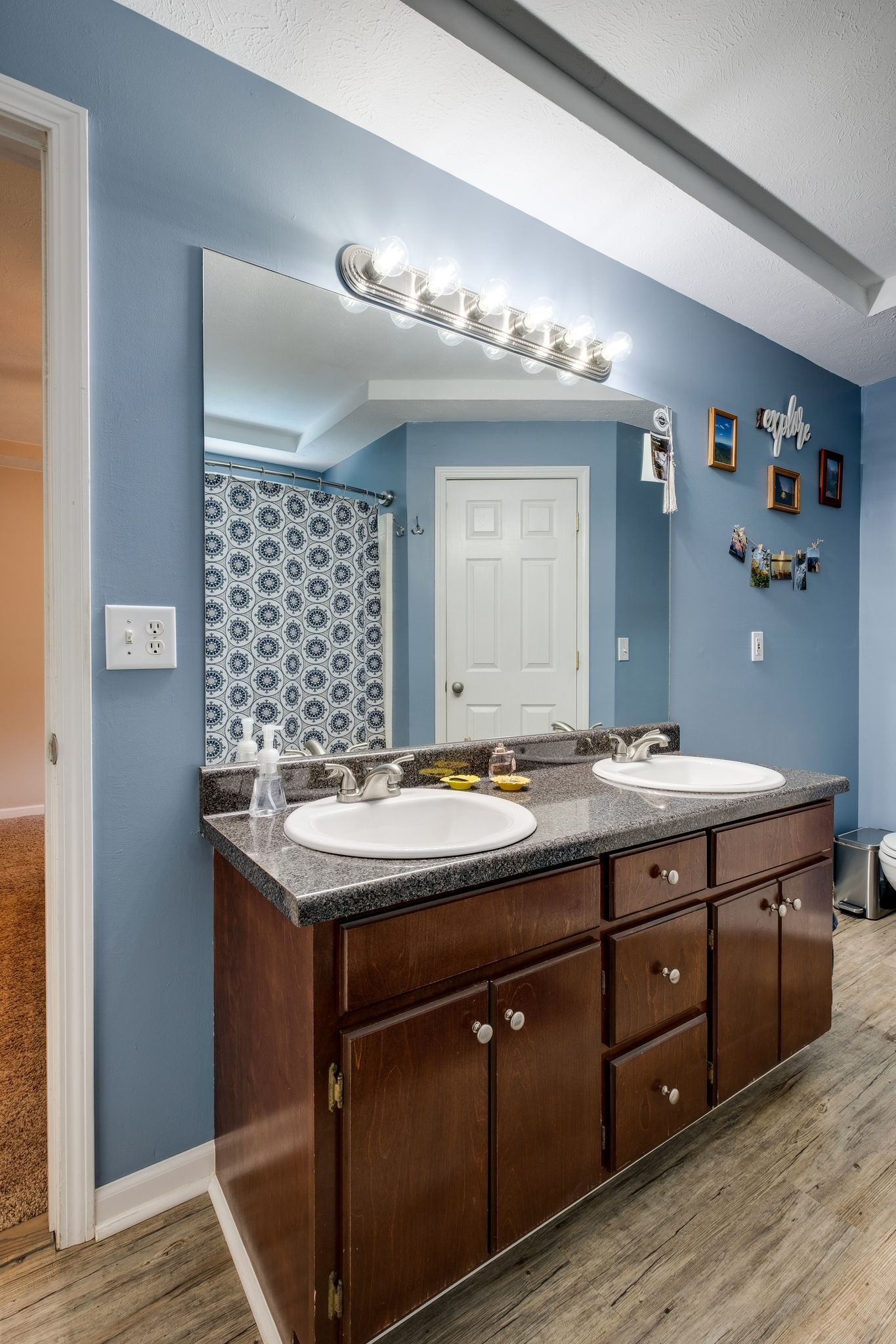 1040 Windtree Trace Mount Juliet, TN 37122 - Photo 18 of 30 a bathroom with a granite countertop sink a large mirror and a shower