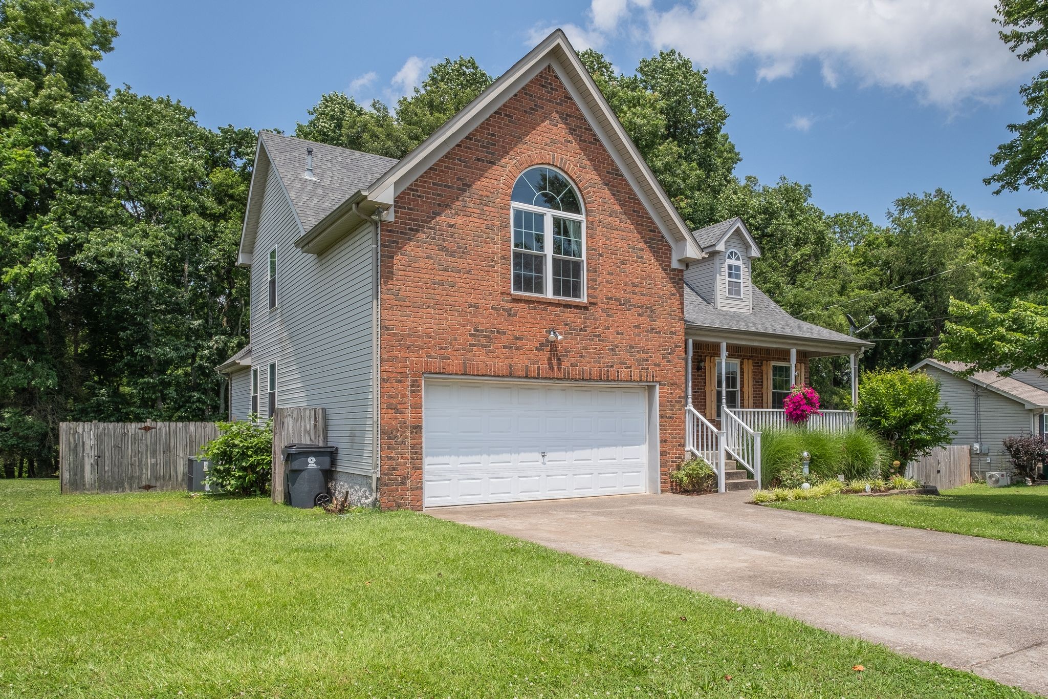 1040 Windtree Trace Mount Juliet, TN 37122 - Photo 2 of 30 a front view of a house with a yard and garage