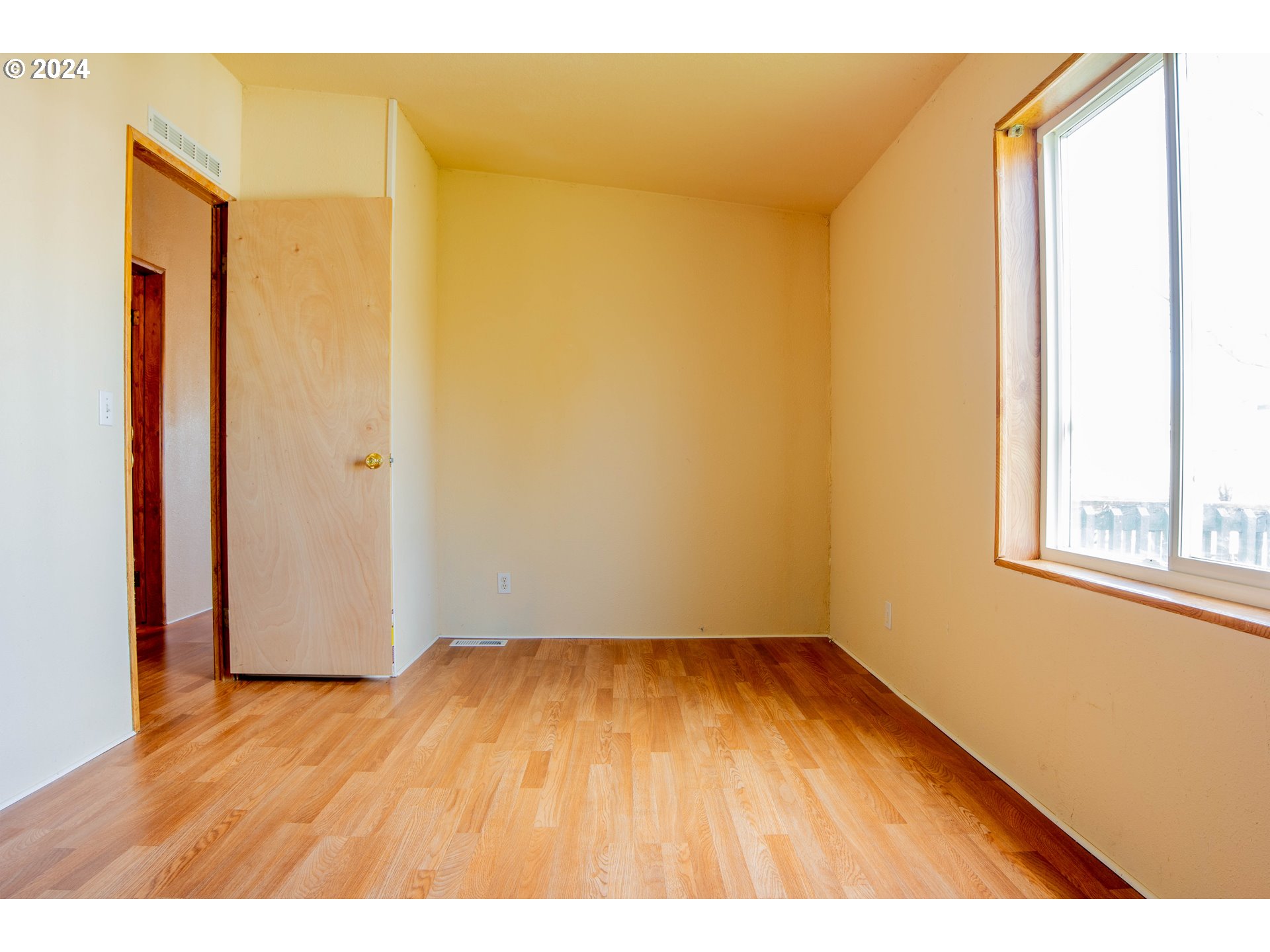 2151 Three Lakes Road Southeast, Unit 17 Albany, OR 97322 - Photo 13 of 34 a view of an empty room with wooden floor and a window