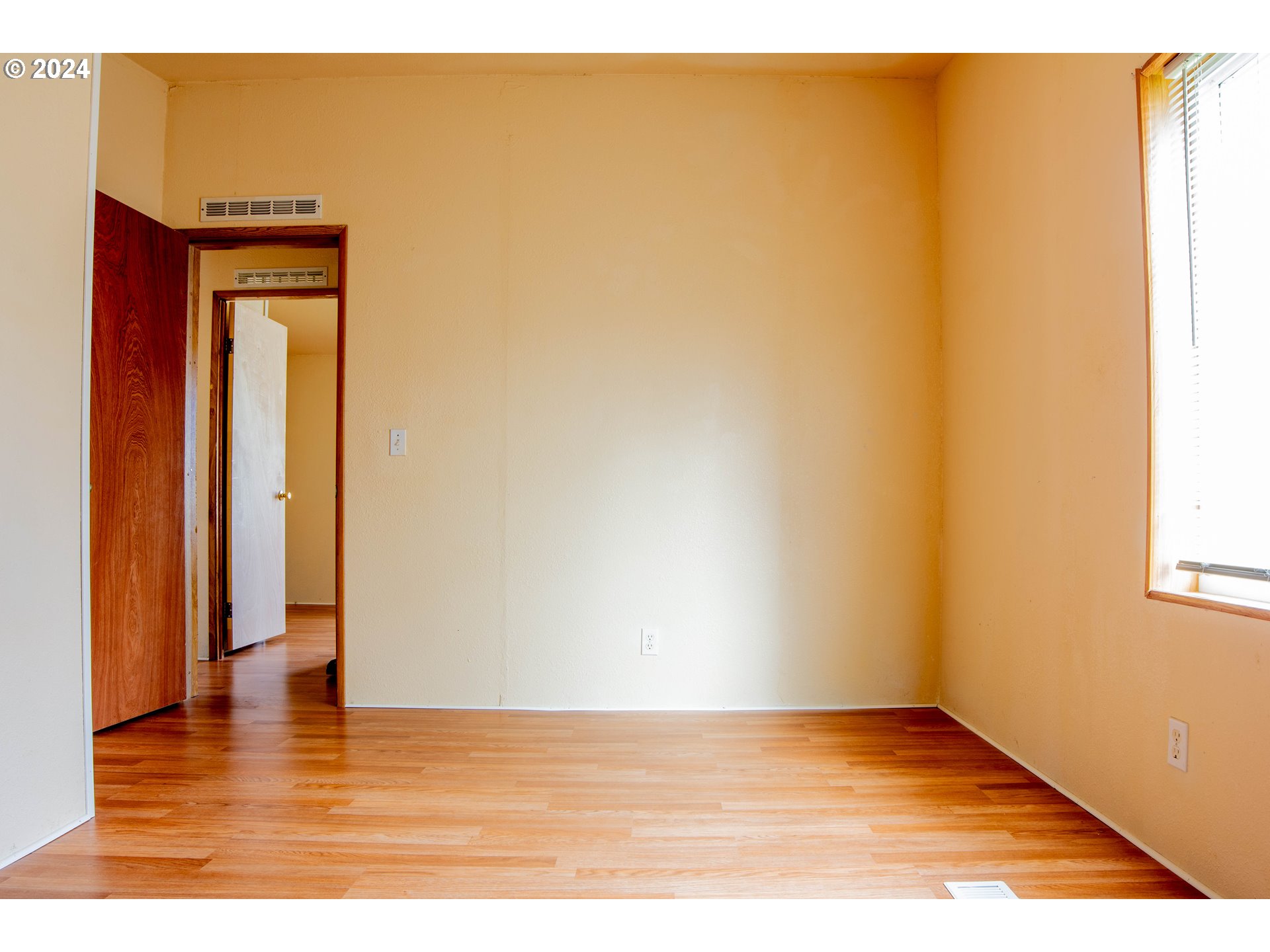 2151 Three Lakes Road Southeast, Unit 17 Albany, OR 97322 - Photo 14 of 34 a view of an empty room with wooden floor and a window