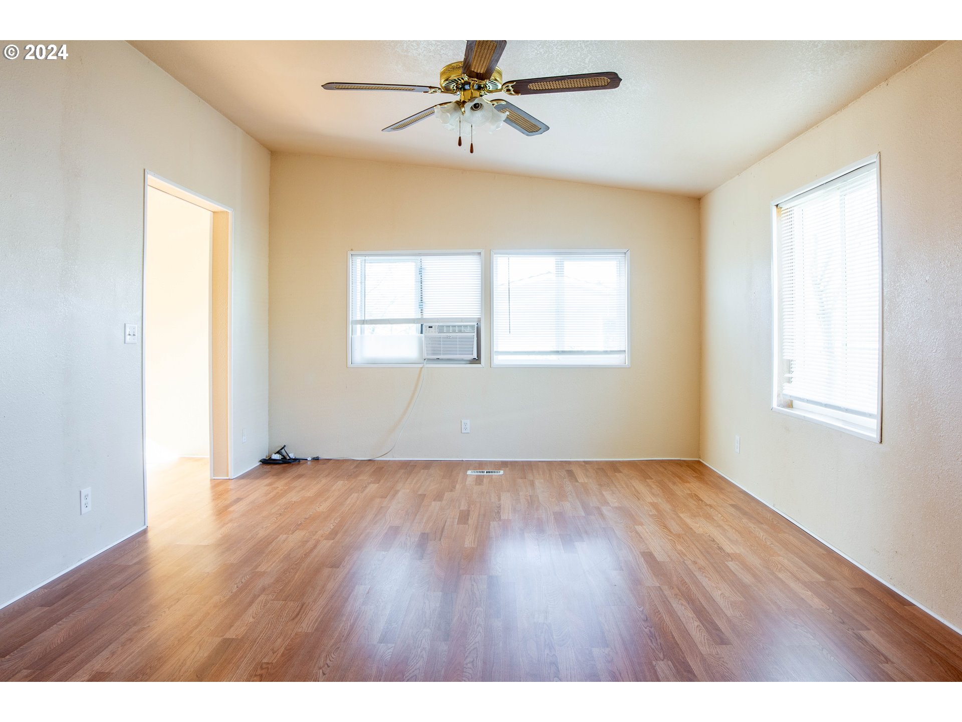 2151 Three Lakes Road Southeast, Unit 17 Albany, OR 97322 - Photo 5 of 34 a view of an empty room with a window and wooden floor