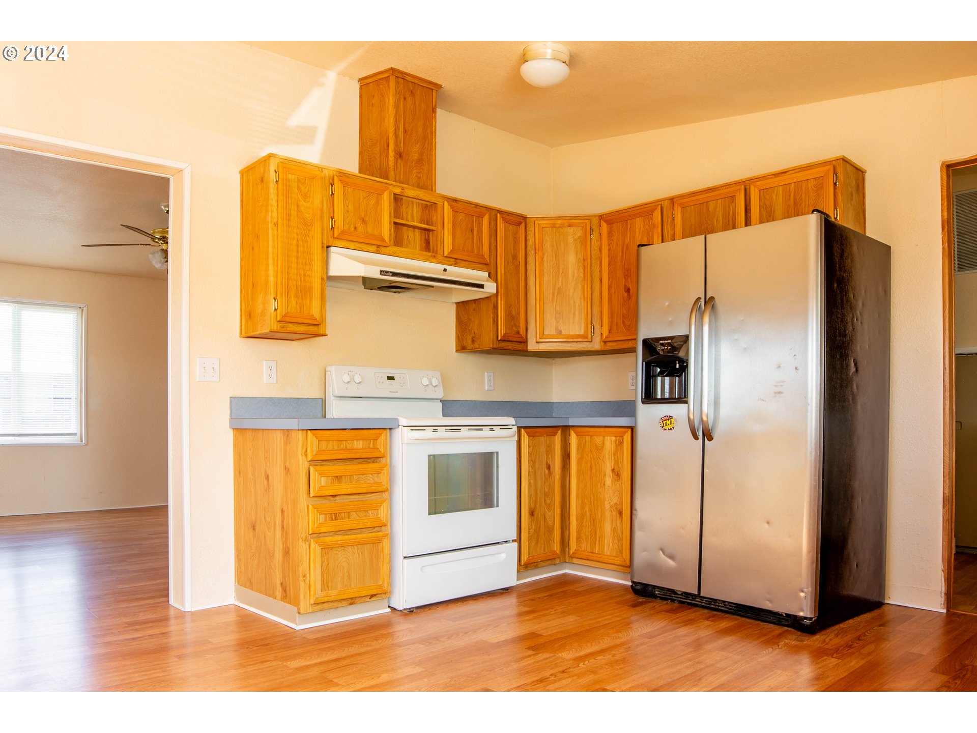 2151 Three Lakes Road Southeast, Unit 17 Albany, OR 97322 - Photo 8 of 34 a view of a kitchen with wooden floor and a refrigerator