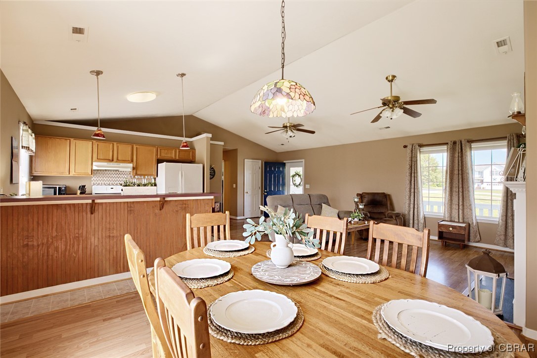 118 Edwards Court Dutton, VA 23050 - Photo 16 of 24 Dining room featuring light wood-type flooring, lofted ceiling, and ceiling fan