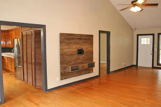 wooden floor in an empty room with a window