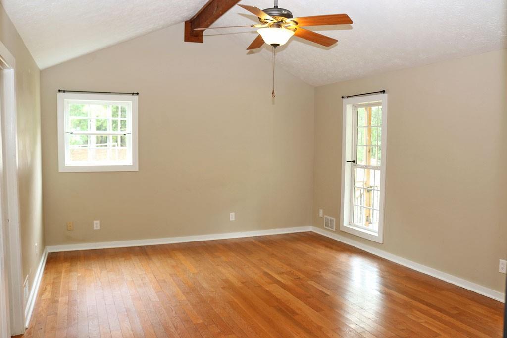 3129 Etchison Road Loganville, GA 30052 - Photo 12 of 58 wooden floor in an empty room with a window