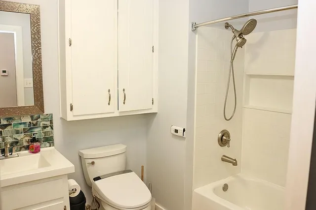 a view of living room with baby crib and furniture