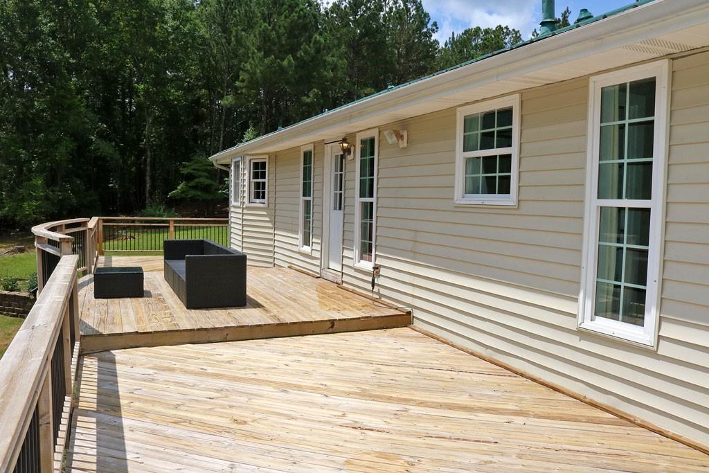 3129 Etchison Road Loganville, GA 30052 - Photo 30 of 58 a view of a roof deck with wooden floor and seating space