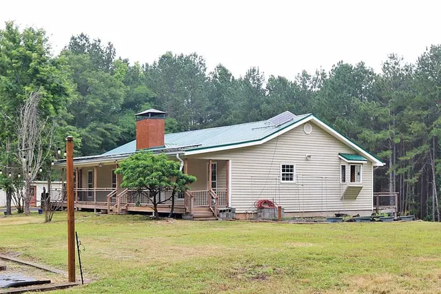 a view of a house with a yard patio and swimming pool