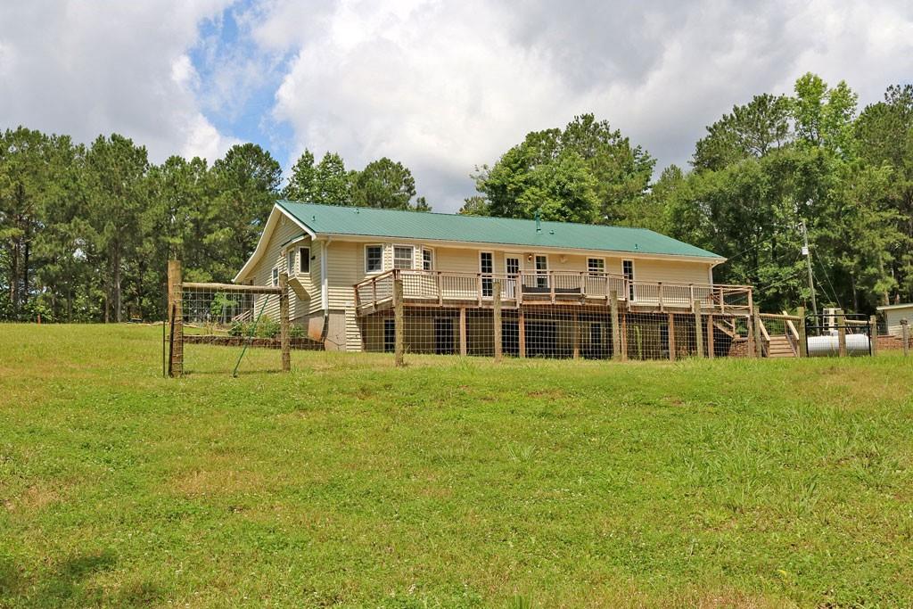 3129 Etchison Road Loganville, GA 30052 - Photo 33 of 58 a view of a house next to a big yard and large trees
