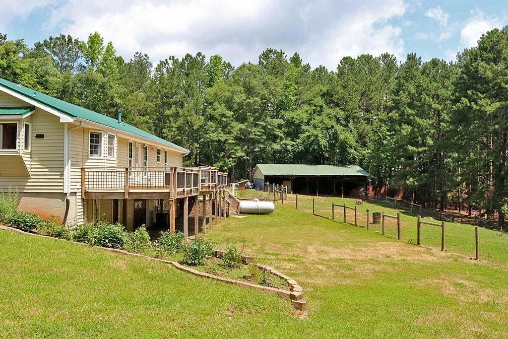 3129 Etchison Road Loganville, GA 30052 - Photo 34 of 58 a view of a house with swimming pool and sitting area