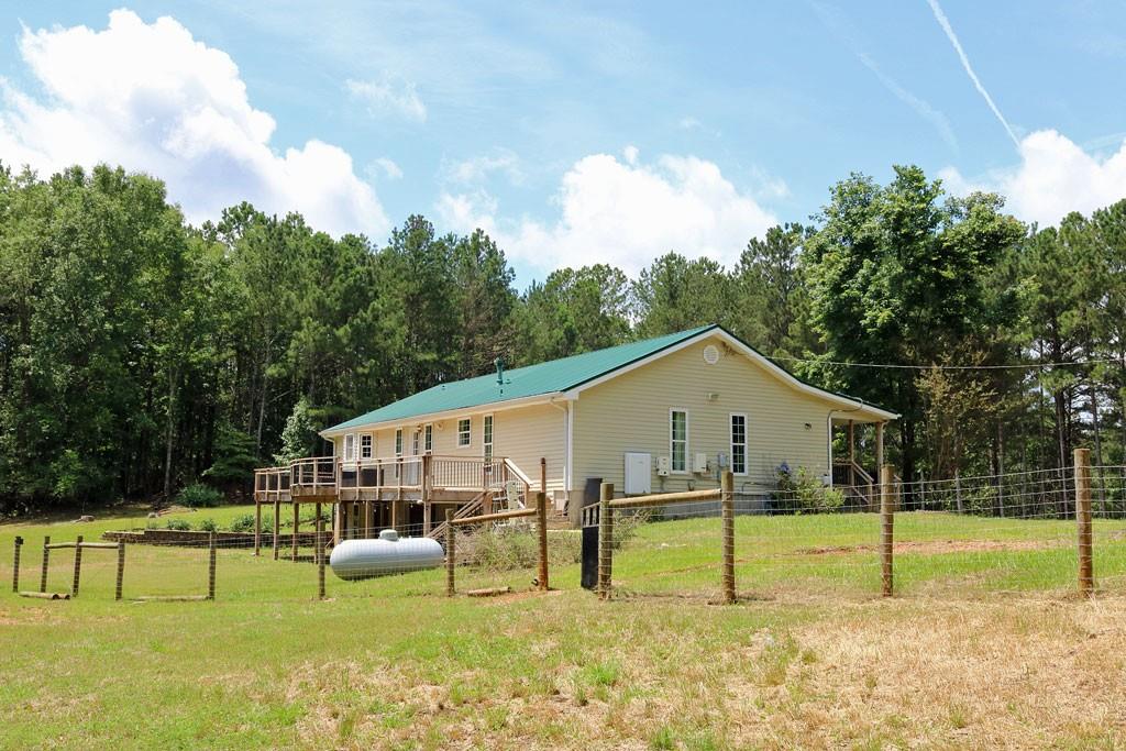 3129 Etchison Road Loganville, GA 30052 - Photo 35 of 58 a view of an house with backyard and swimming pool