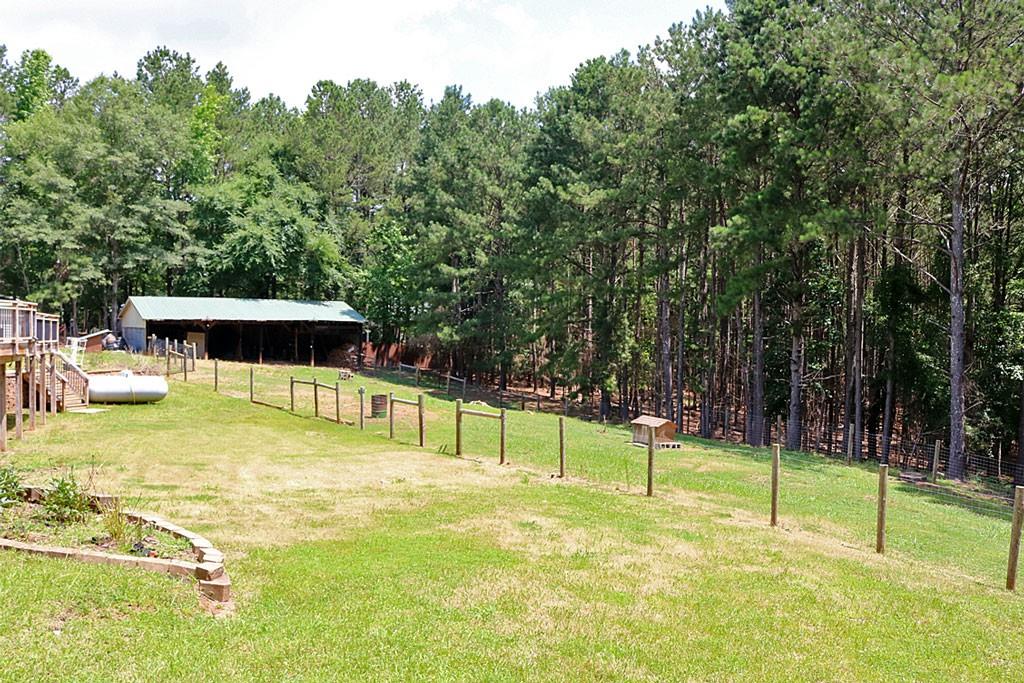 3129 Etchison Road Loganville, GA 30052 - Photo 38 of 58 a view of a swimming pool with a chair and tables