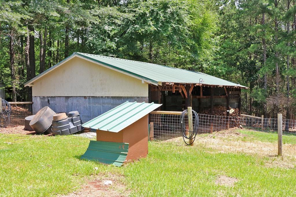 3129 Etchison Road Loganville, GA 30052 - Photo 41 of 58 a backyard of a house with barbeque oven