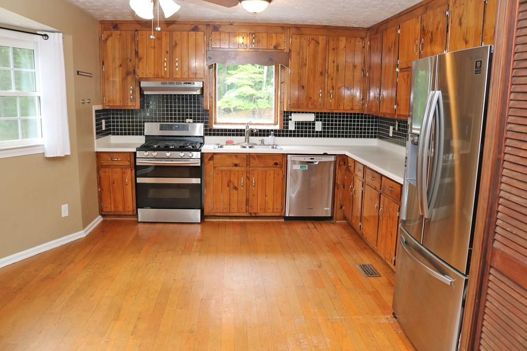 3129 Etchison Road Loganville, GA 30052 - Photo 5 of 58 a kitchen with stainless steel appliances a refrigerator stove and sink