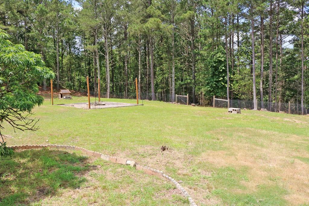 3129 Etchison Road Loganville, GA 30052 - Photo 52 of 58 a view of swimming pool with a big yard and large trees
