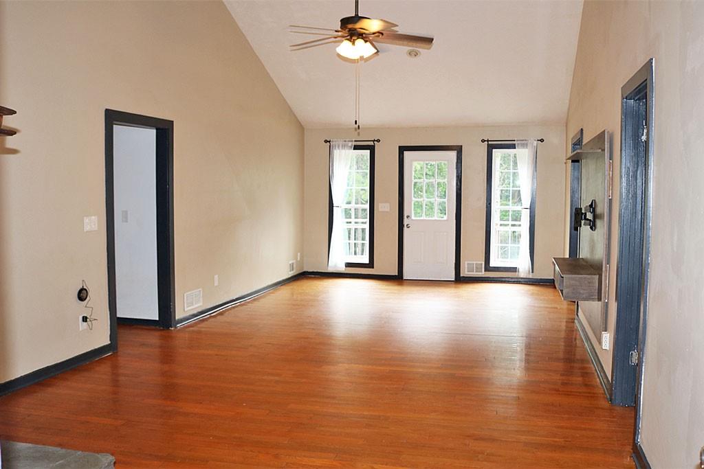 3129 Etchison Road Loganville, GA 30052 - Photo 9 of 58 a view of an empty room with wooden floor and a window