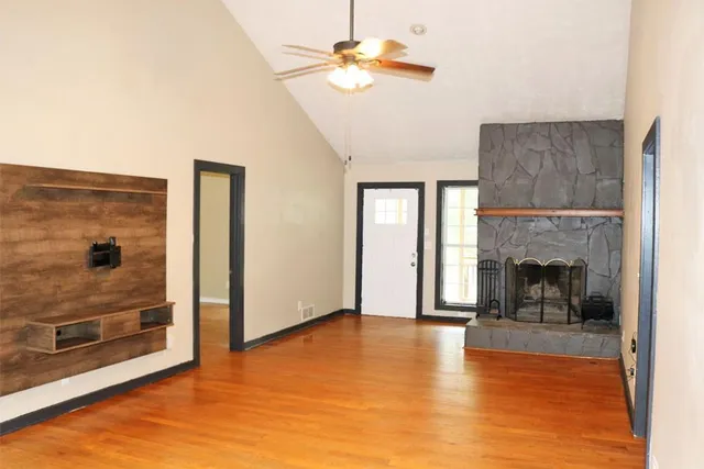 a view of a livingroom with a fireplace and window