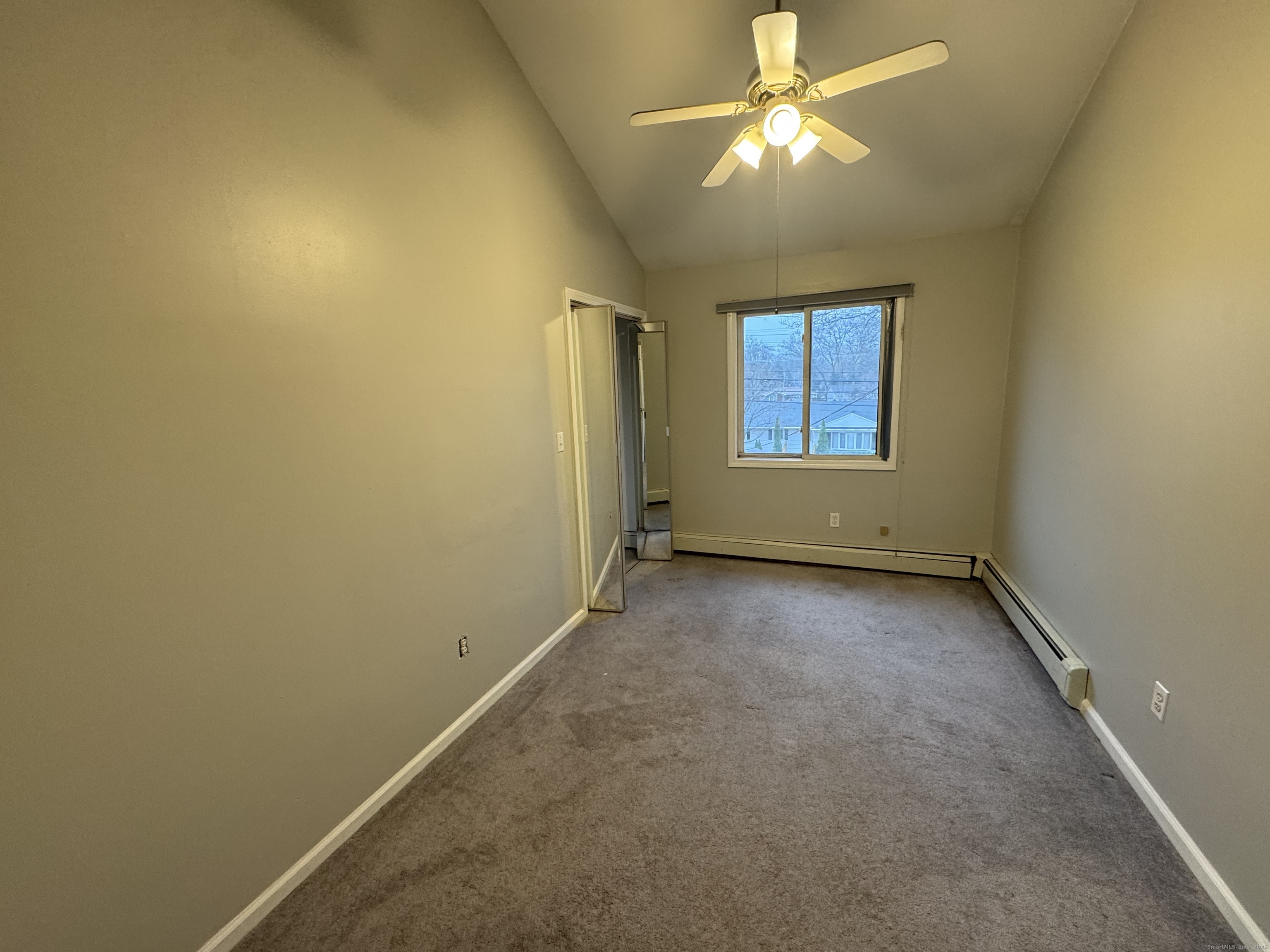 1880 Old Town Road Trumbull, CT 06611 - Photo 1 of 5 an empty room with a window and a fan