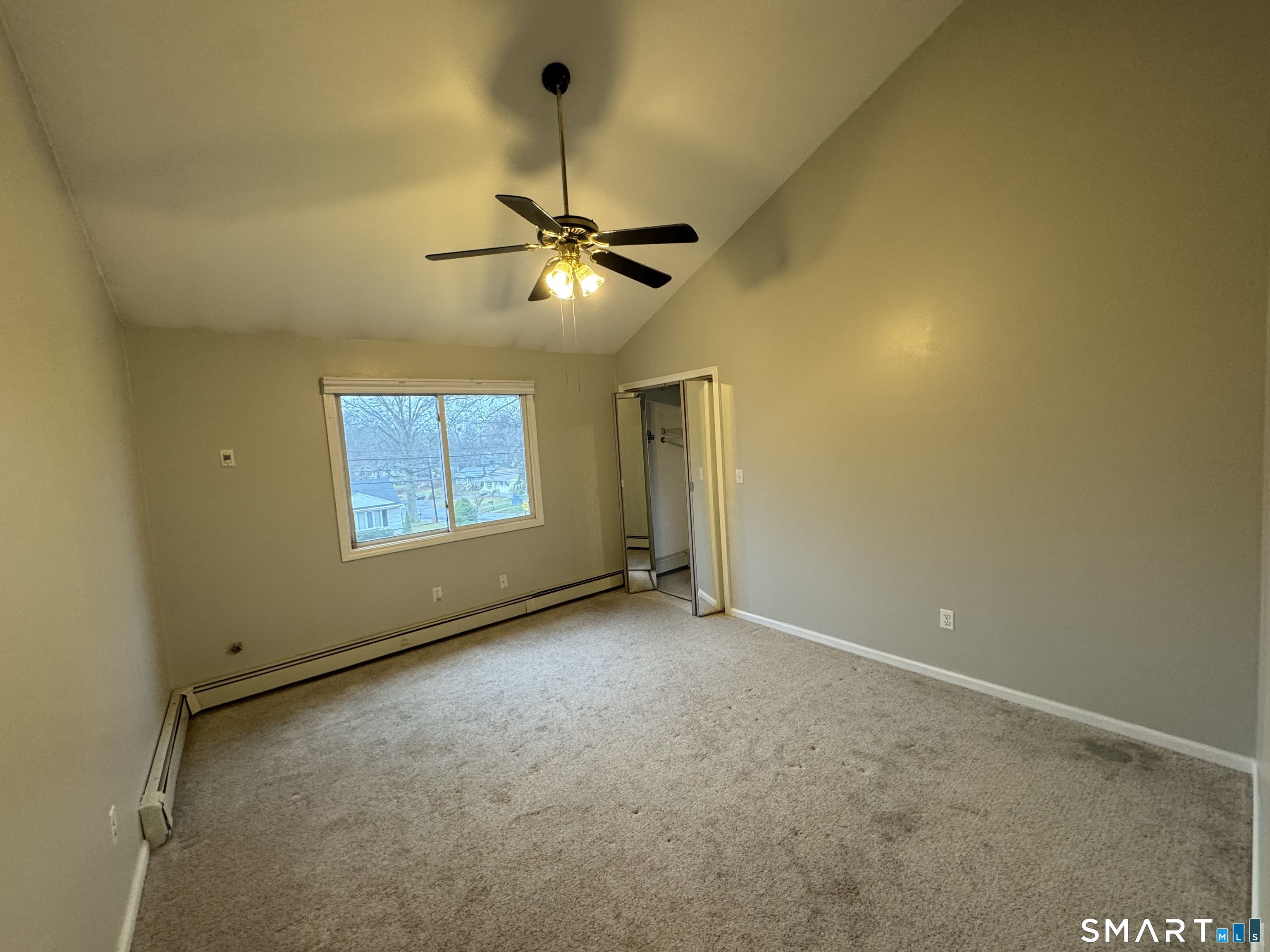 1880 Old Town Road Trumbull, CT 06611 - Photo 13 of 18 an empty room with a ceiling fan and a window