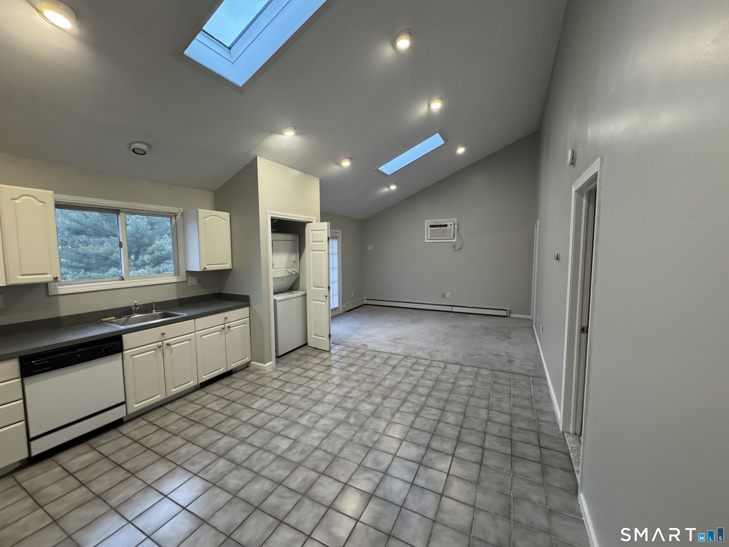 1880 Old Town Road Trumbull, CT 06611 - Photo 4 of 18 a large white kitchen with a sink and dishwasher a stove top oven with wooden floor