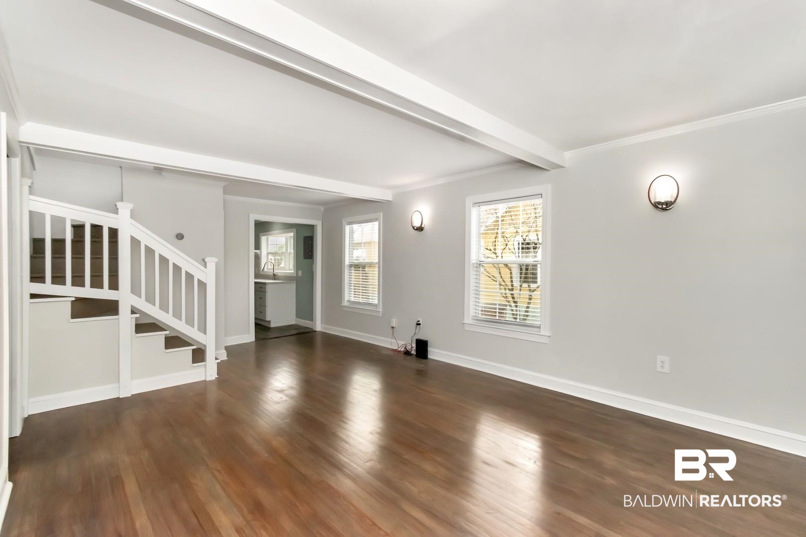 2157 Homewood Street Mobile, AL 36606 - Photo 2 of 36 Unfurnished living room featuring beam ceiling, crown molding, stairway, wood finished floors, and baseboards