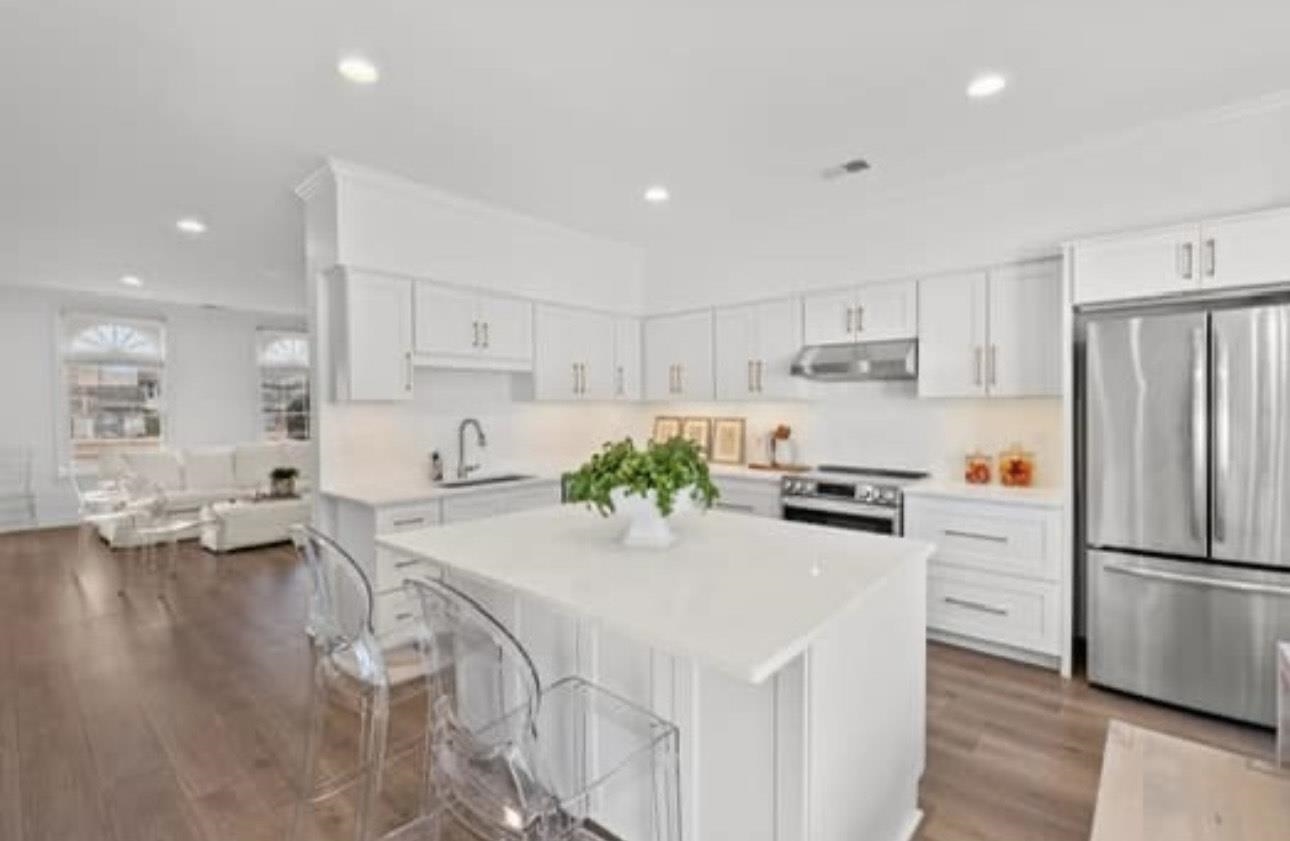 1687 Kimbrough Road, Unit 1687 Germantown, TN 38138 - Photo 2 of 19 Kitchen with appliances with stainless steel finishes, white cabinets, light countertops, recessed lighting, and a center island
