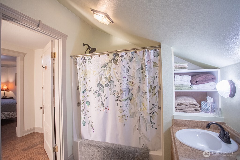 951 Bulman Road Southeast Port Orchard, WA 98366 - Photo 24 of 39 a bathroom with a sink toilet and shower curtain