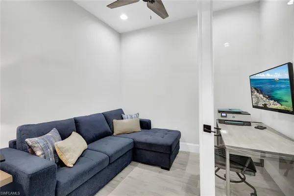 a living room with furniture and a flat screen tv