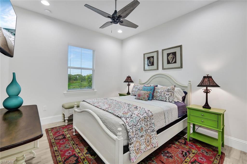 7142 Cayo Coco Lane Naples, FL 34113 - Photo 13 of 17 a bed room with a bed and a chair