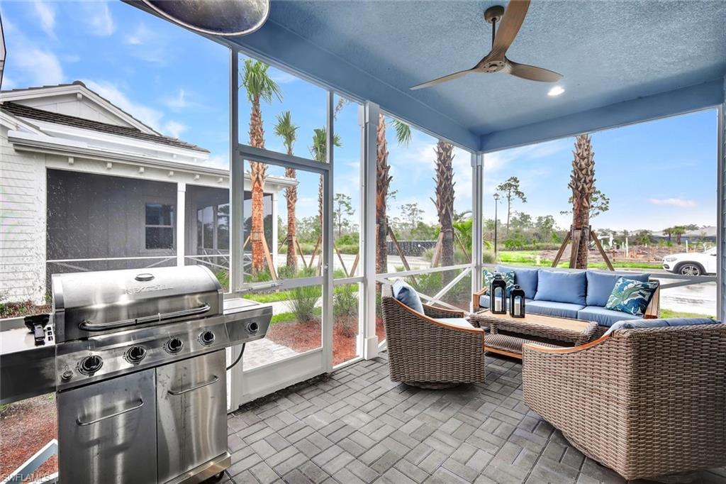 7142 Cayo Coco Lane Naples, FL 34113 - Photo 14 of 17 a living room with furniture and a floor to ceiling window
