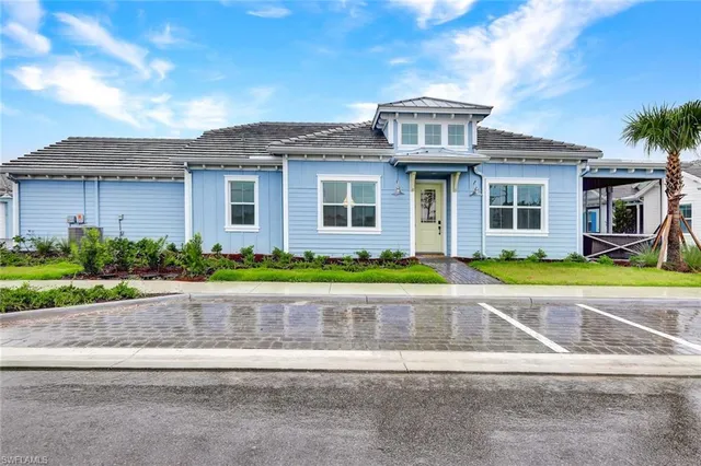 a front view of a house with a garden and plants