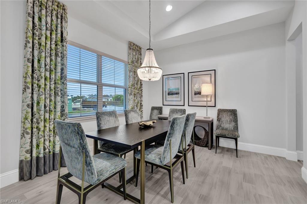 7142 Cayo Coco Lane Naples, FL 34113 - Photo 4 of 17 a view of a dining room with furniture and window