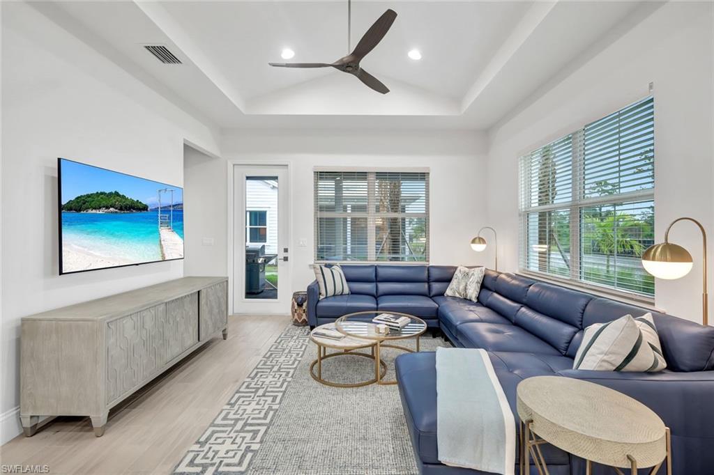 7142 Cayo Coco Lane Naples, FL 34113 - Photo 5 of 17 a living room with furniture and a large window