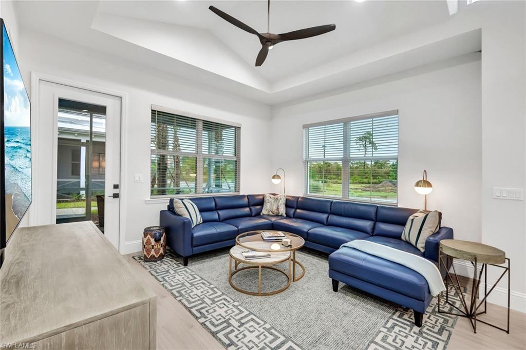 7142 Cayo Coco Lane Naples, FL 34113 - Photo 6 of 17 a living room with furniture and a large window