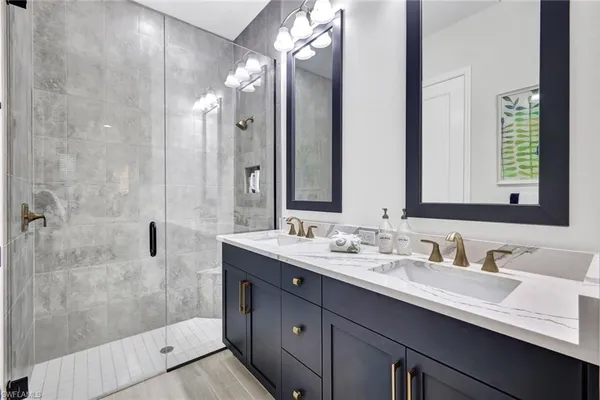 a bathroom with a double vanity sink mirror and double