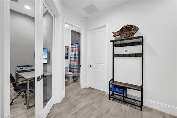 a living room with furniture and a wooden floor