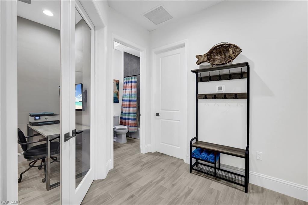 7142 Cayo Coco Lane Naples, FL 34113 - Photo 10 of 17 a living room with furniture and a wooden floor