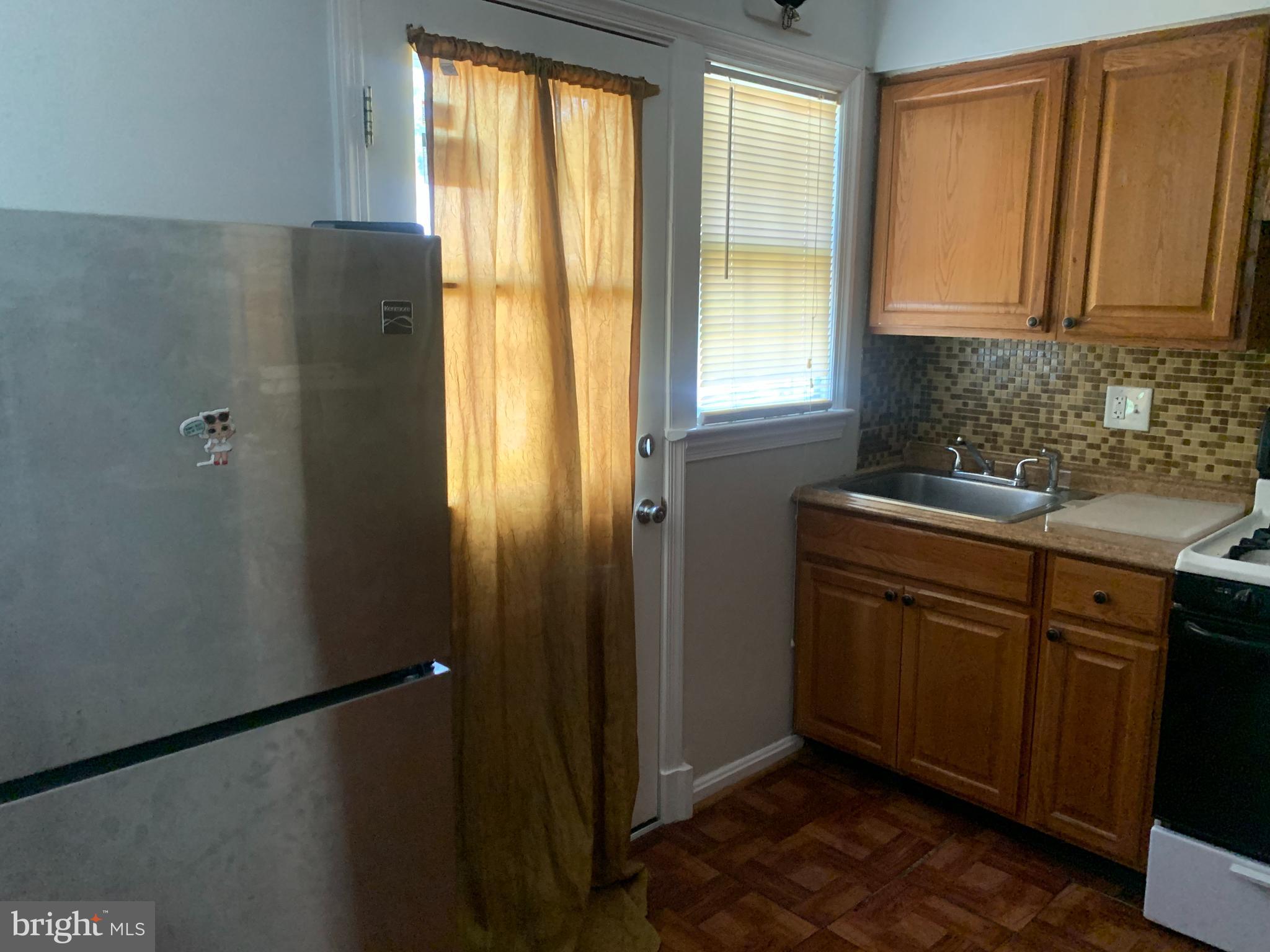 1760 East W Highway Silver Spring, MD 20910 - Photo 4 of 21 a kitchen with a window a sink and cabinets