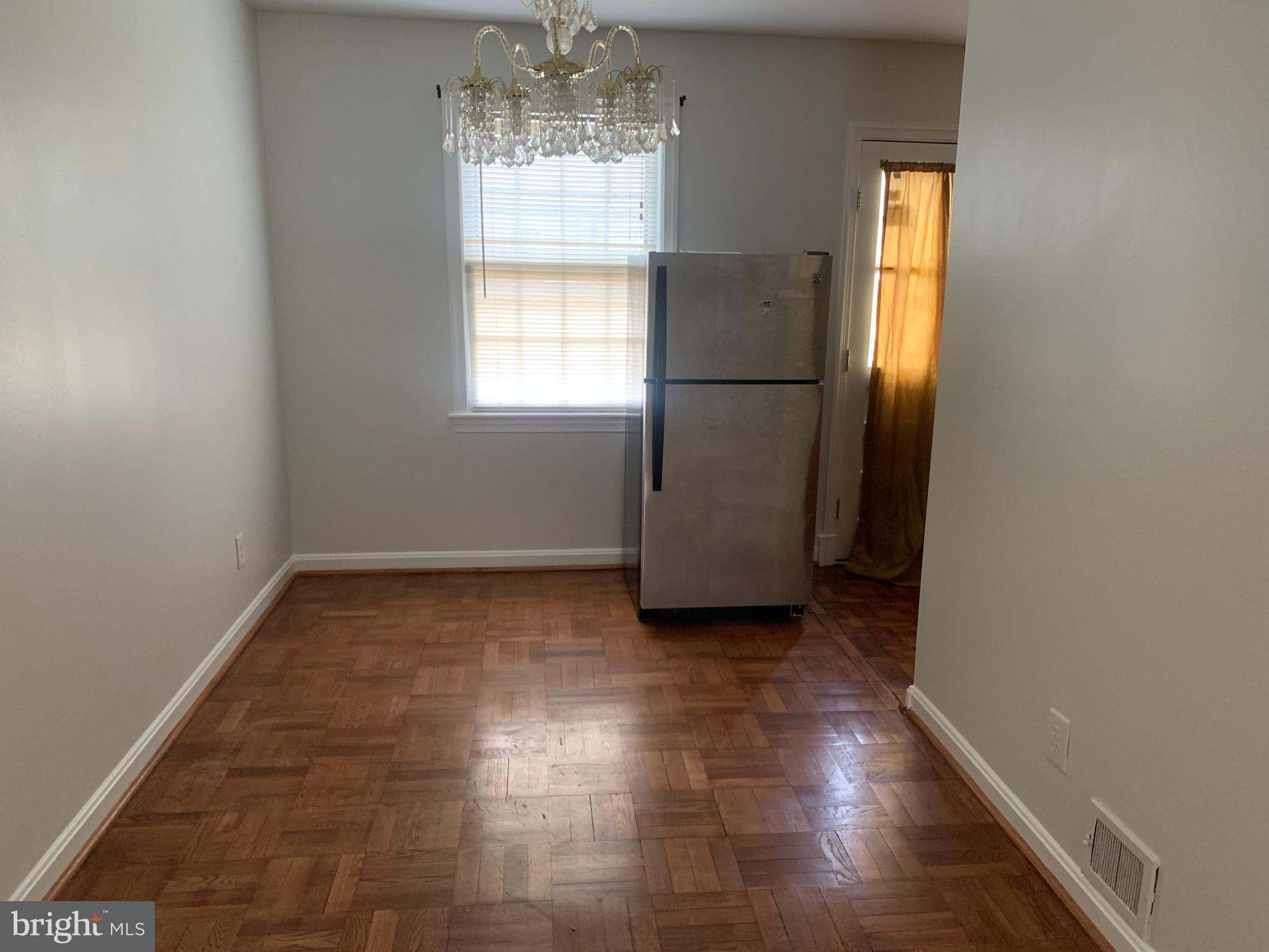 1760 East W Highway Silver Spring, MD 20910 - Photo 5 of 21 a view of a hallway to rooms and wooden floor