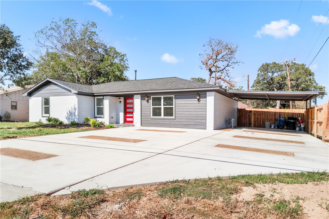 3004 Woodville Road Bryan, TX 77803 - Photo 2 of 26 a view of a house with a patio and a yard