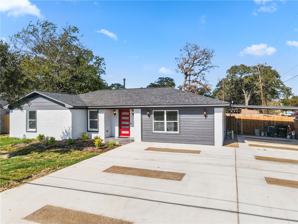 3004 Woodville Road Bryan, TX 77803 - Photo 25 of 26 a front view of a house with yard