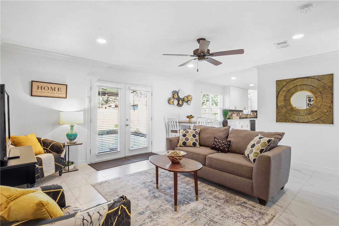 3004 Woodville Road Bryan, TX 77803 - Photo 4 of 26 a living room with furniture and a ceiling fan