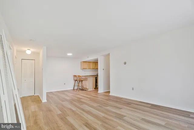 a view of a livingroom with wooden floor and a sink