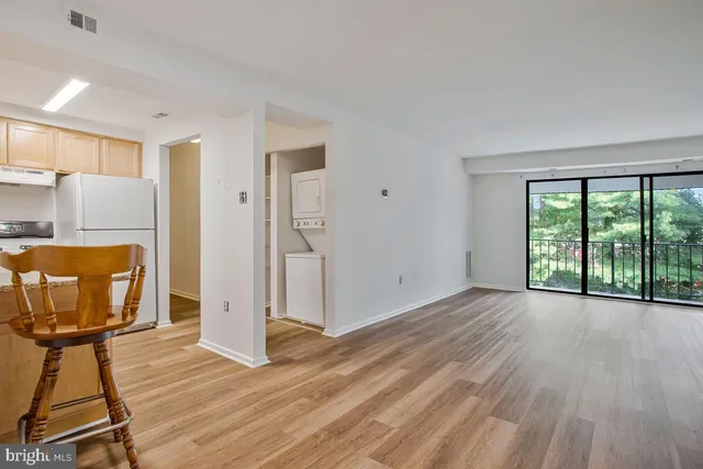 a view of a room with wooden floor and furniture