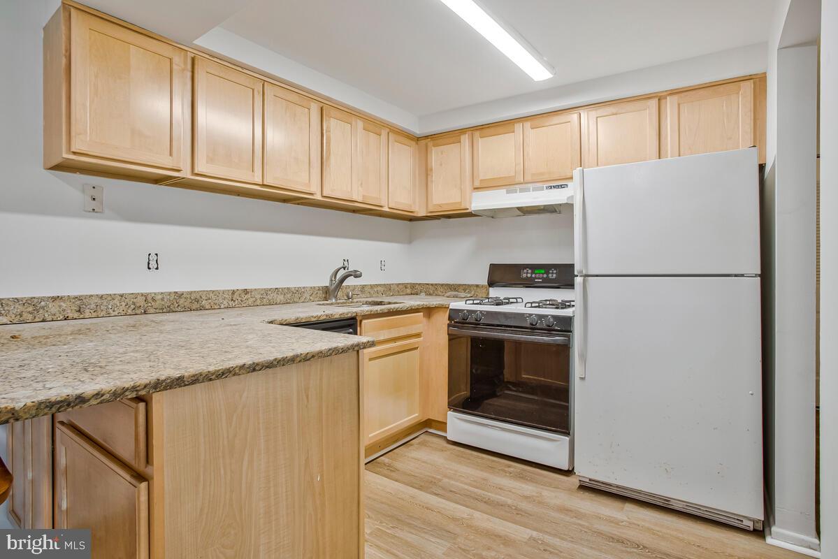 2574 Riva Road, Unit 19A Annapolis, MD 21401 - Photo 20 of 35 a kitchen with granite countertop a sink stainless steel appliances and cabinets