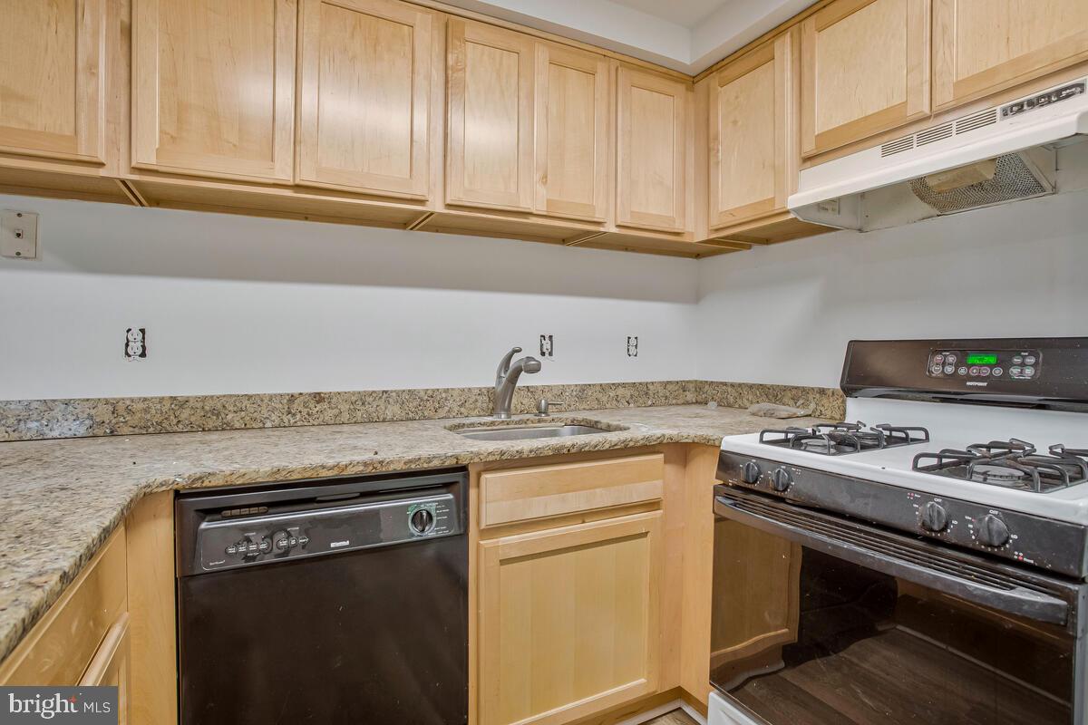 2574 Riva Road, Unit 19A Annapolis, MD 21401 - Photo 22 of 35 a kitchen with stainless steel appliances granite countertop a sink stove and cabinets