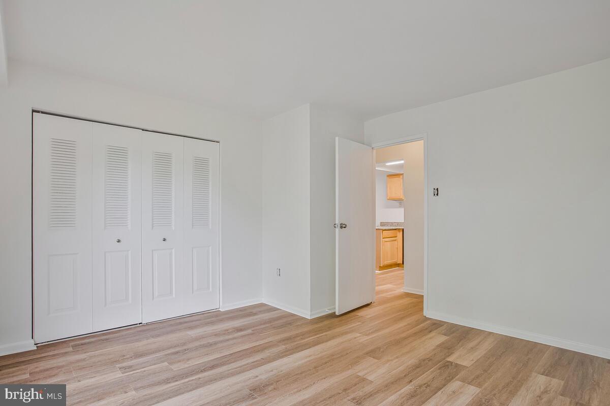 2574 Riva Road, Unit 19A Annapolis, MD 21401 - Photo 25 of 35 a view of an empty room with wooden floor and closet