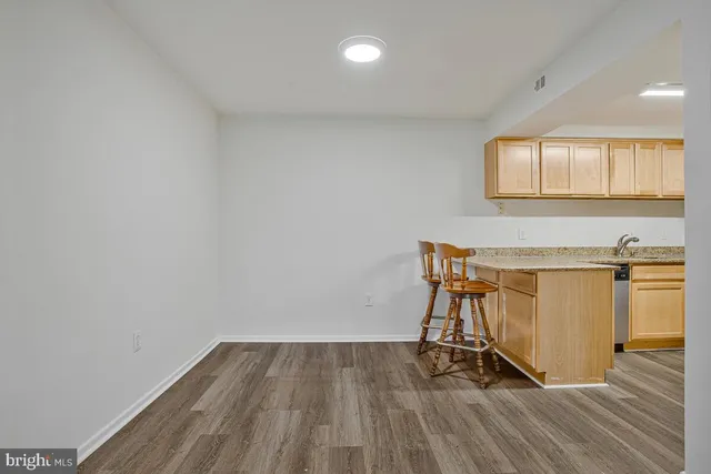 a view of a room with wooden floor and pool table