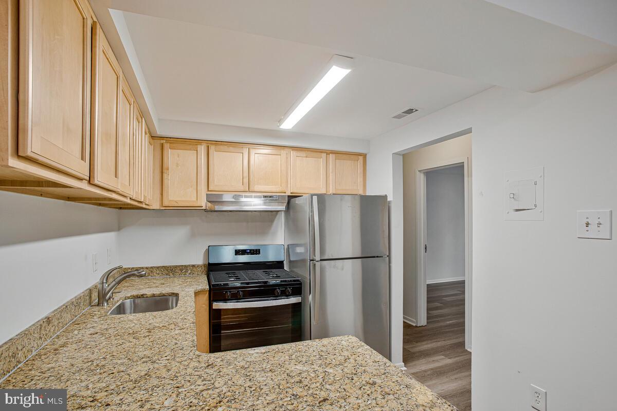 2574 Riva Road, Unit 19A Annapolis, MD 21401 - Photo 6 of 35 a kitchen with stainless steel appliances granite countertop a refrigerator sink and stove